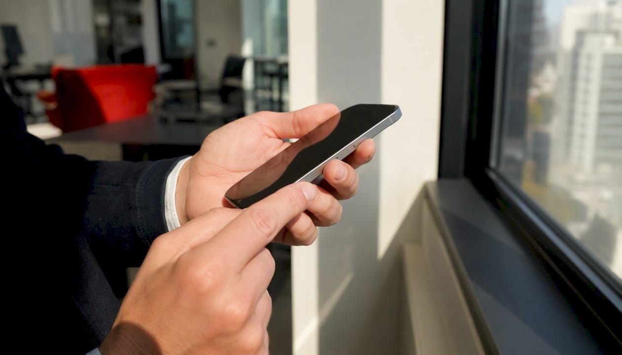 Hands tapping phone eSIM slot edge